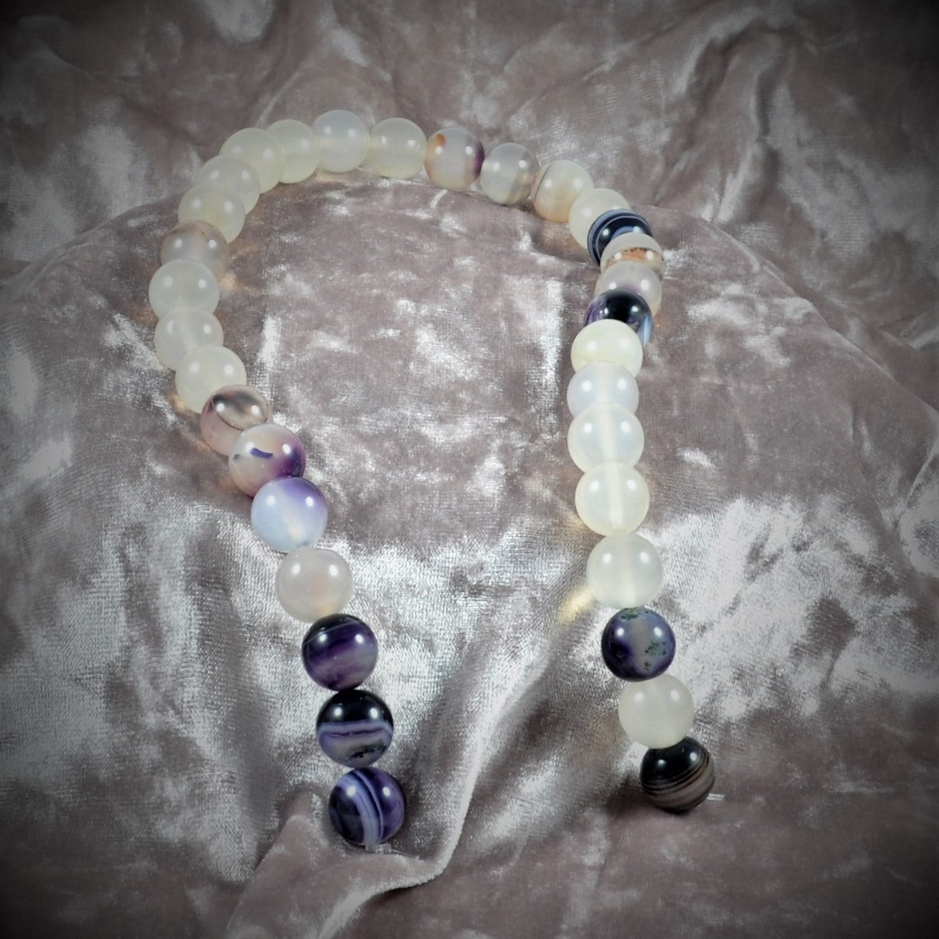 Beaded bracelet with multicolored beads on a textured fabric background