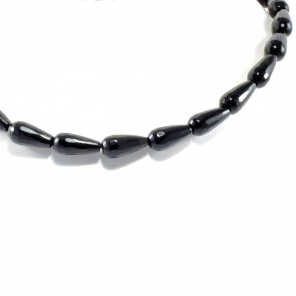 Black beaded necklace on a white background