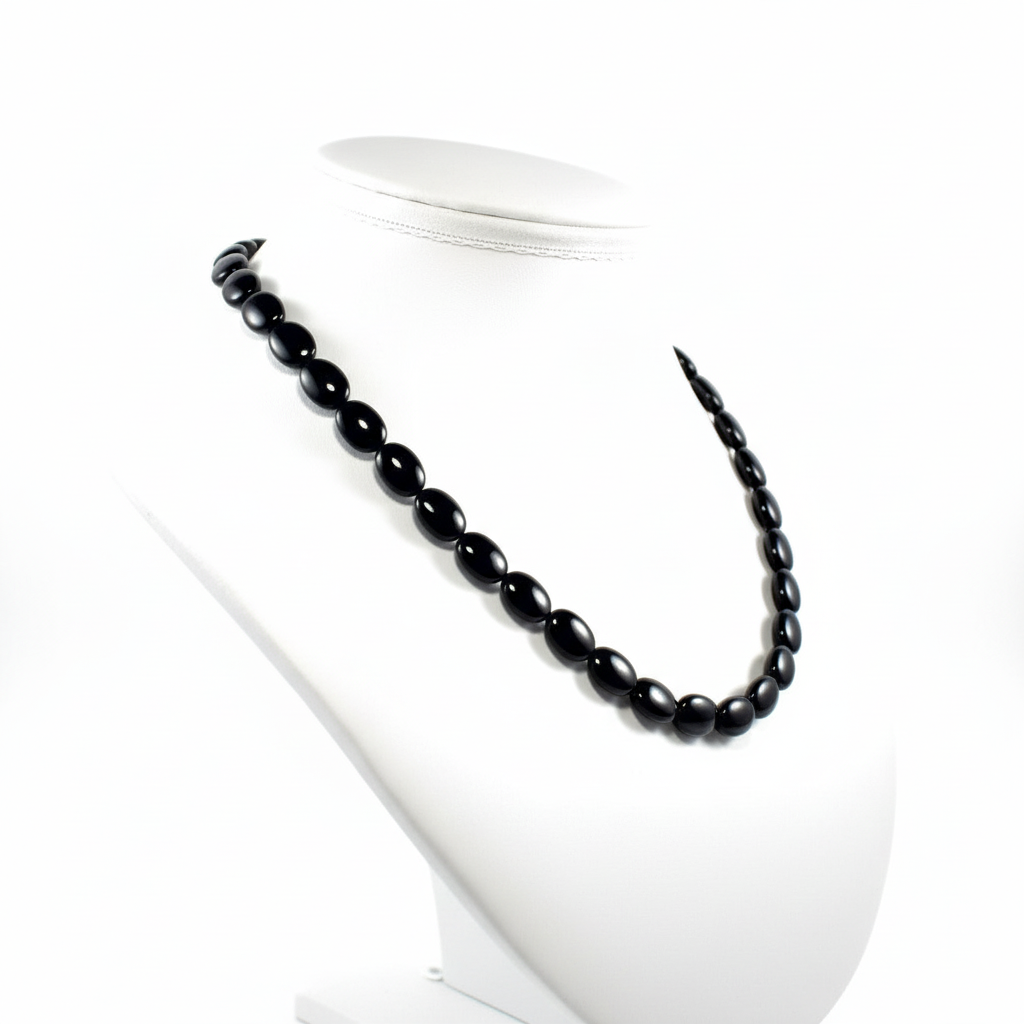 "Side view of black agate flat oval beads showing 5mm flat thickness and comfortable profile"