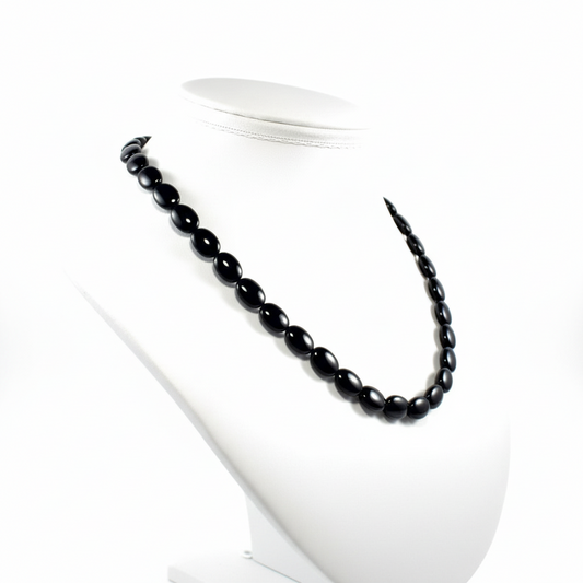 "Side view of black agate flat oval beads showing 5mm flat thickness and comfortable profile"