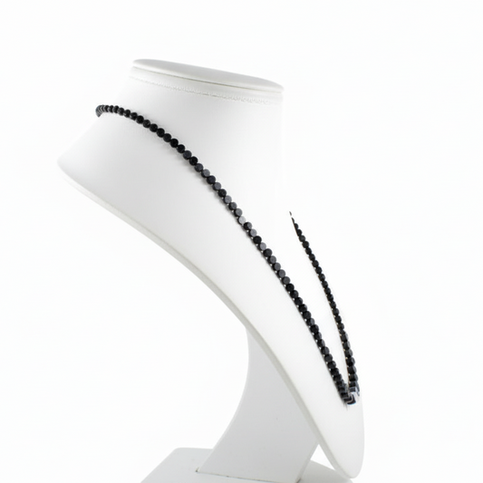 White bust with black decorative agate coins on a white background