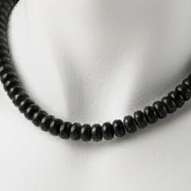 Black beaded necklace on a mannequin