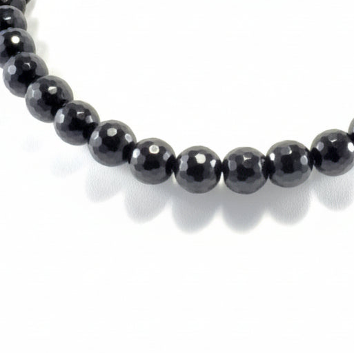 Black beaded bracelet on a white background