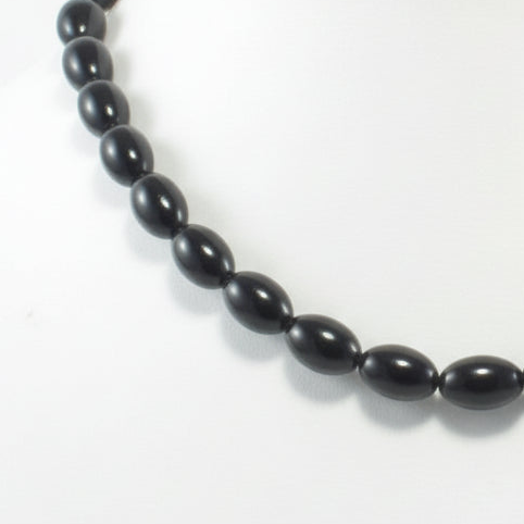 Black beaded necklace on a white background