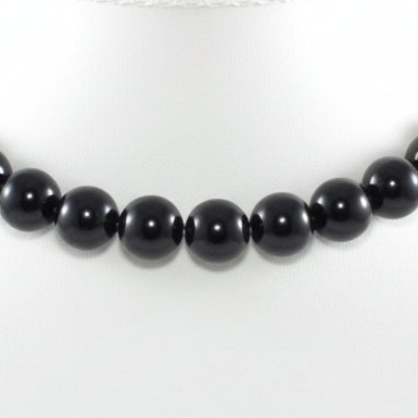Black beaded necklace on a white background