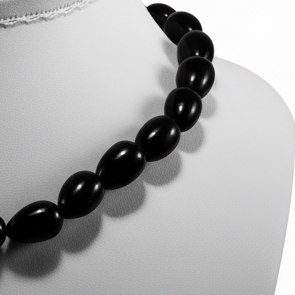 Black beaded necklace on a white background
