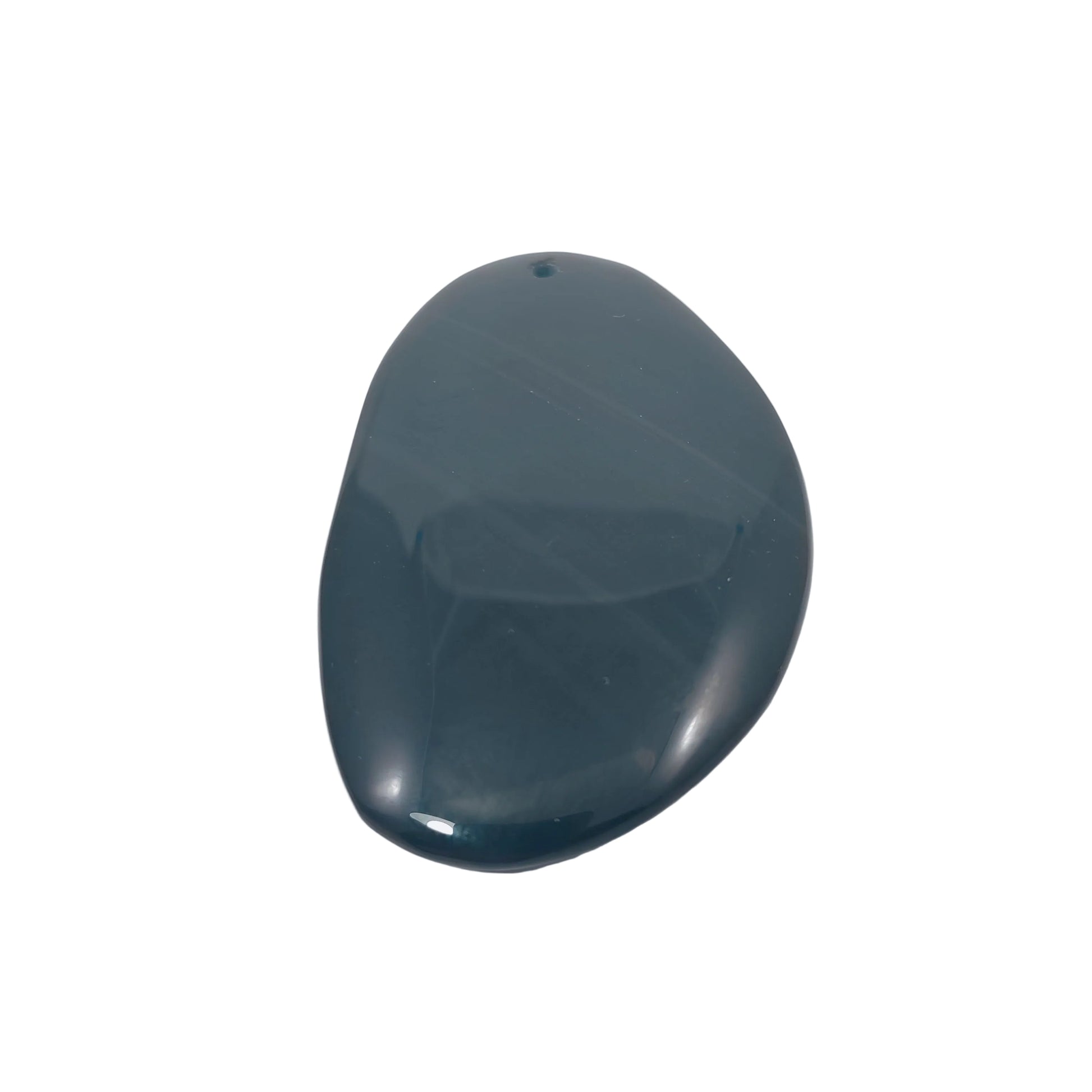 Oval-shaped dark black shiny stone on a light background