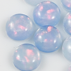 Several round, translucent light blue beads with a soft pink iridescent sheen, arranged on a plain white background.