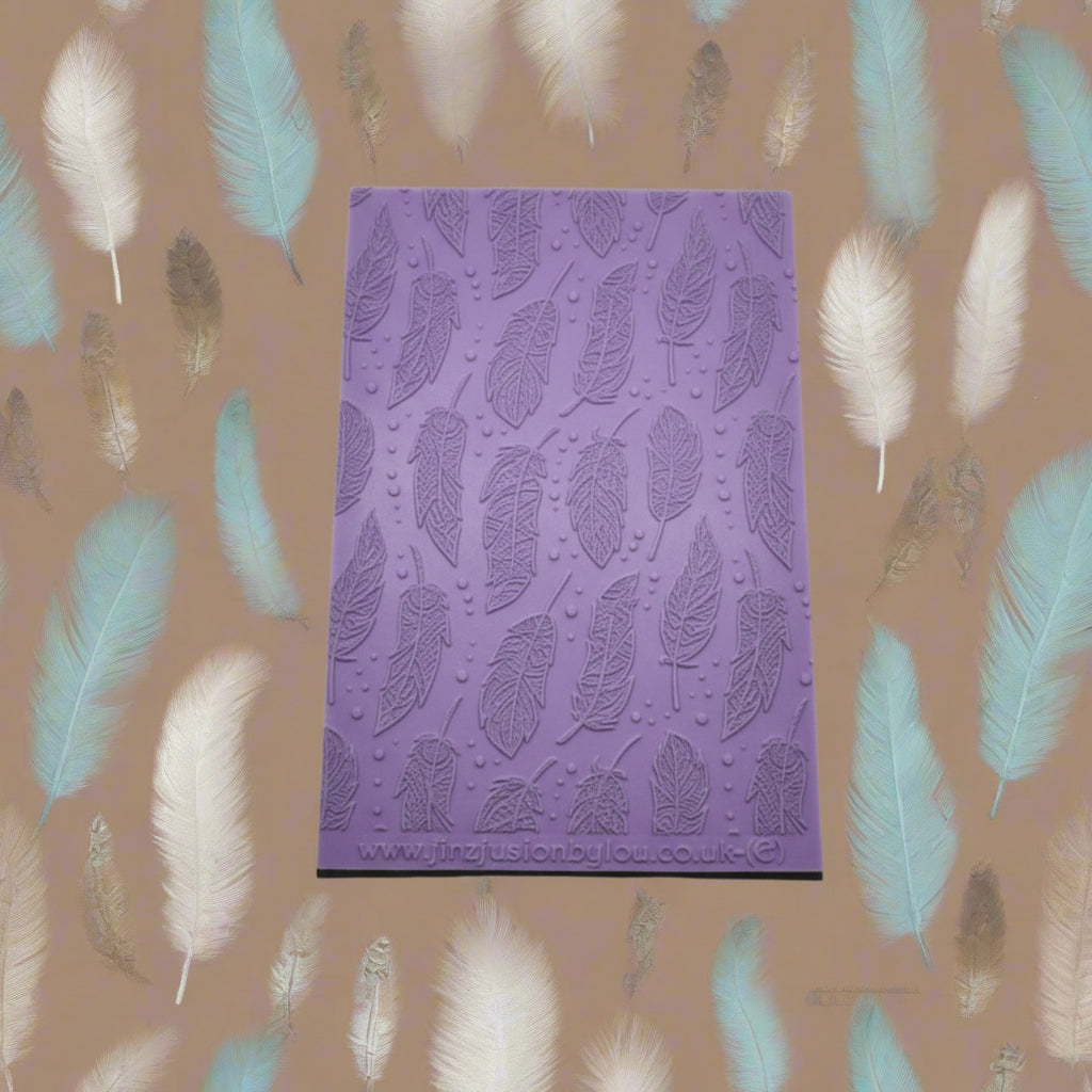A feather pattern embossed texture mat. This texture mat will give you an embossed effect on metal clay or polymer clay.
