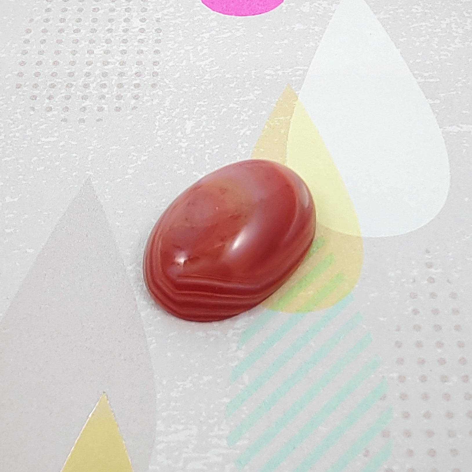Red stone on a colorful abstract background