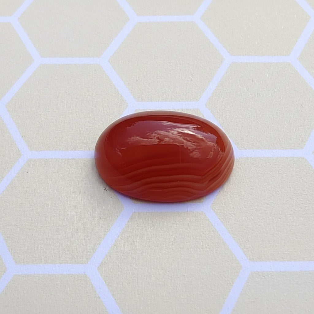 Red stone on a light gray background with hexagonal pattern