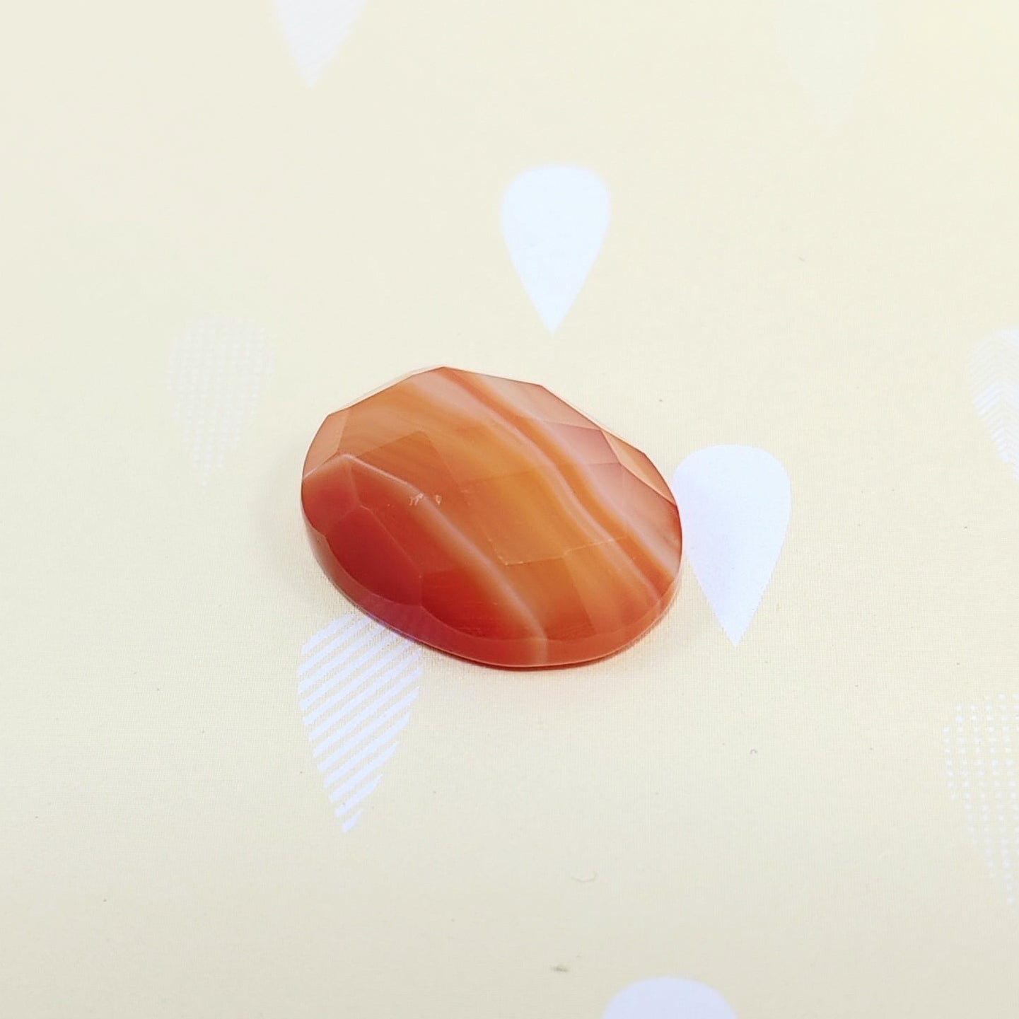 Brown stone on a beige background with white abstract shapes
