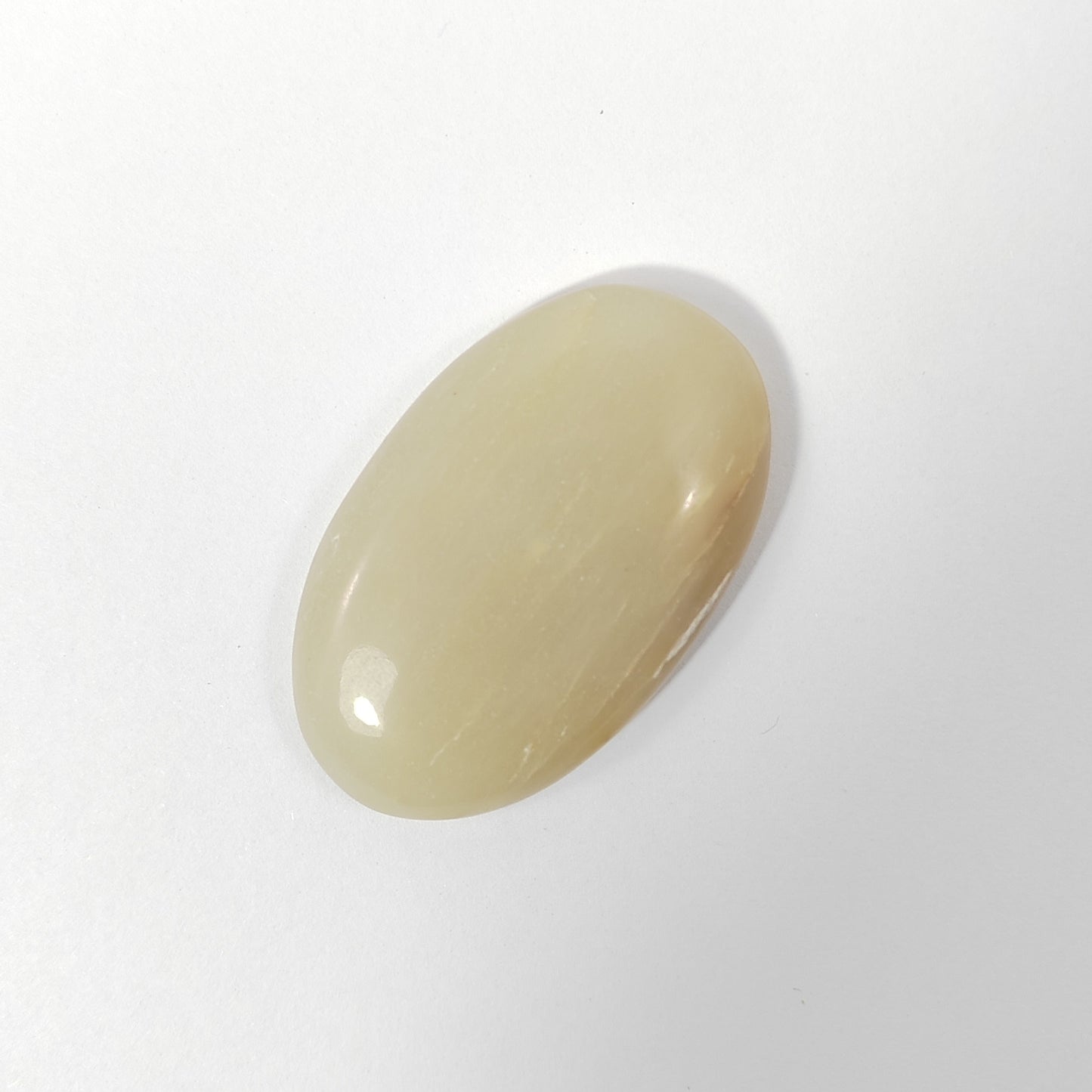 Beige oval stone on a white background