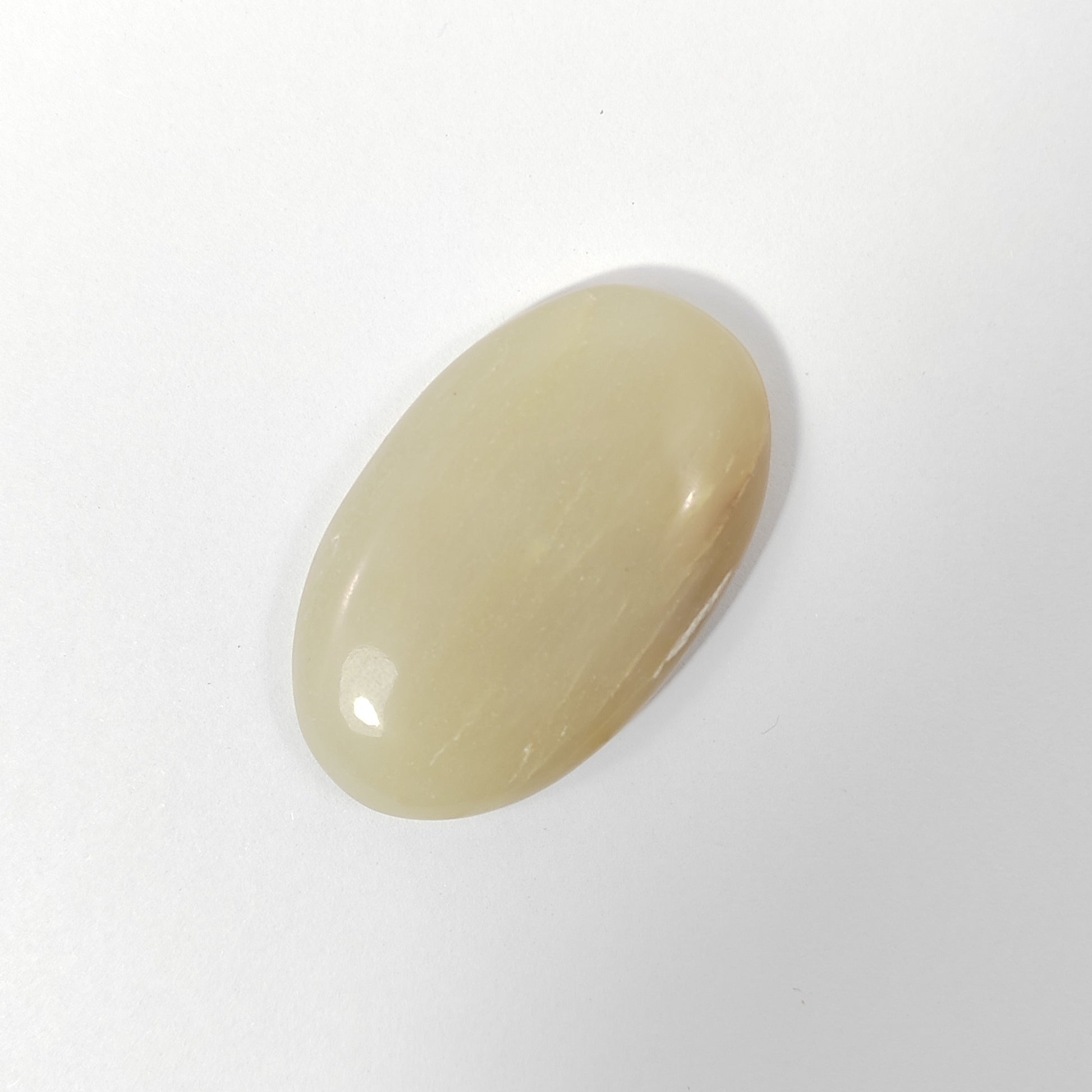 Beige oval stone on a white background