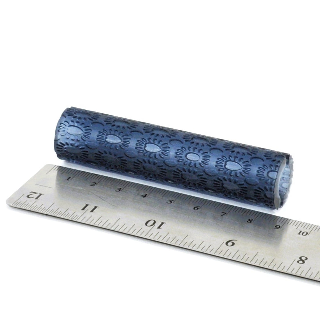 A textured roller with a heart and daisy type repeat design.