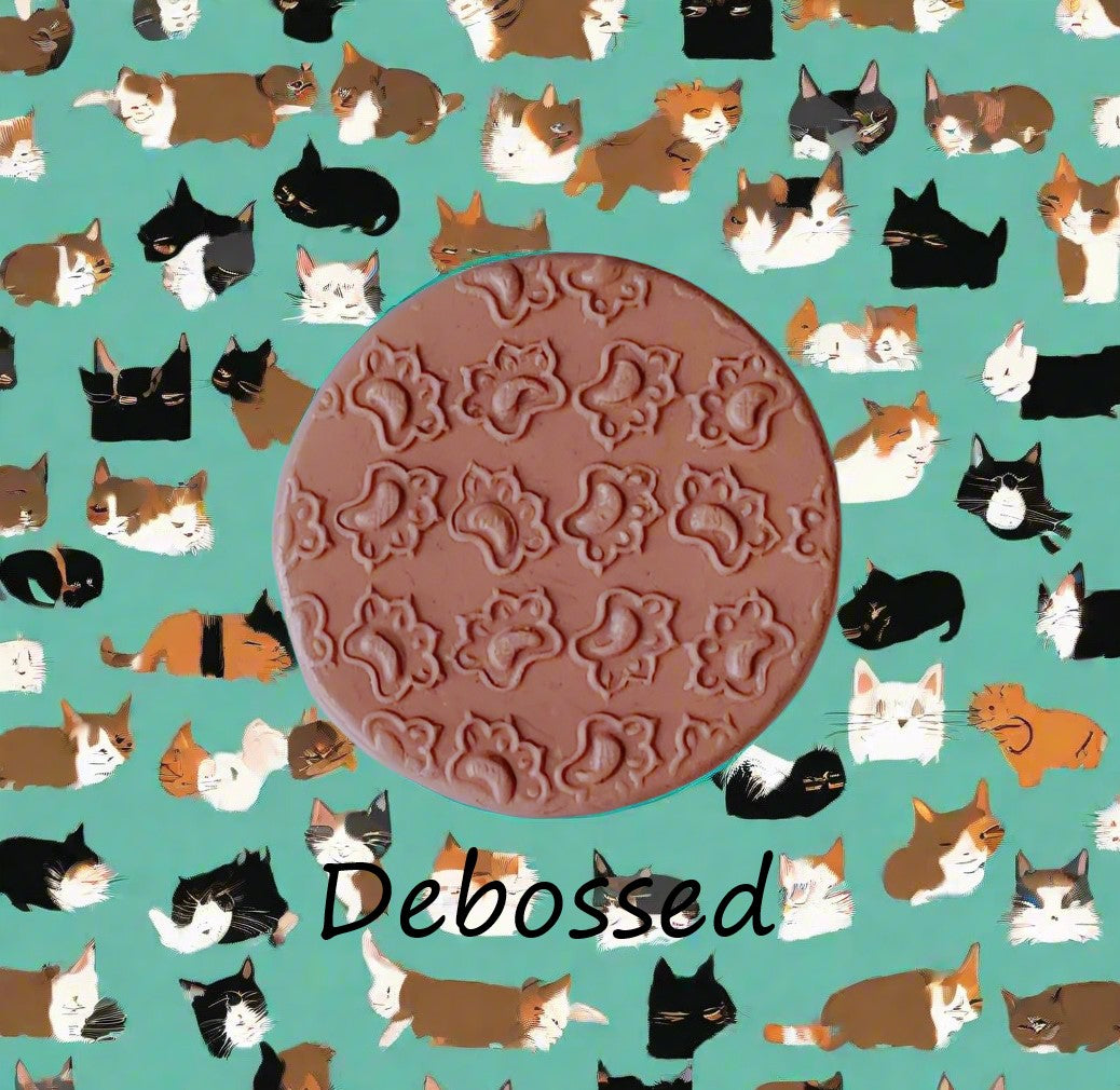 Cat paws embossed in silly putty using a debossed Texture Tile. 