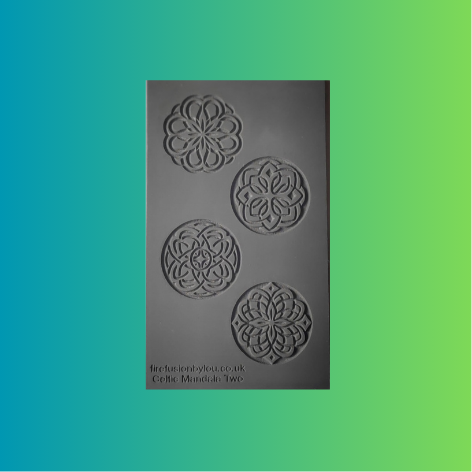 A grey rectangular rubber stamp featuring four Celtic knot and floral mandala designs, shown against a vibrant green-to-blue gradient 