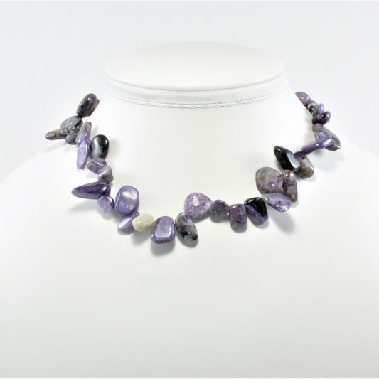 Necklace with purple and gray stones on a white background