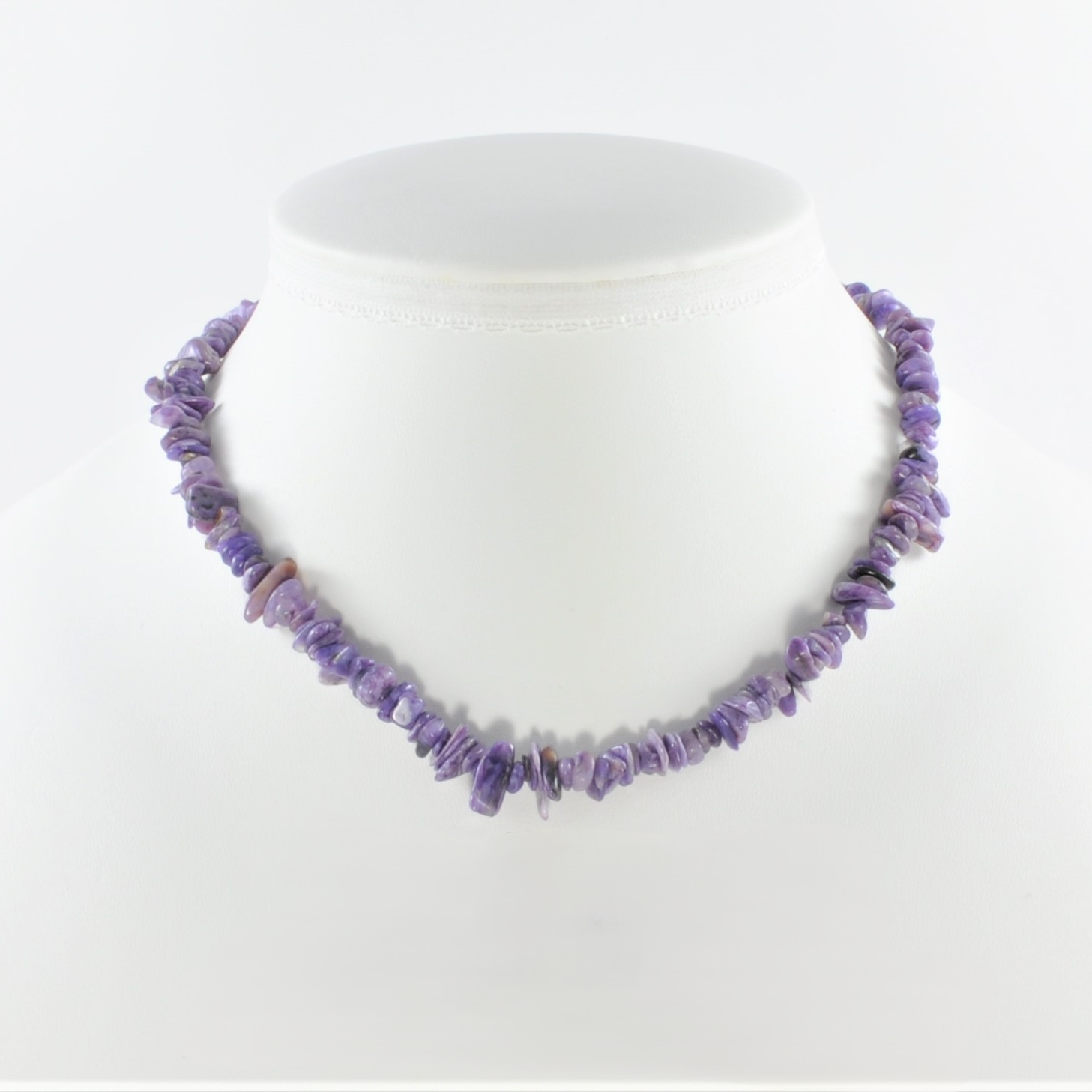 Purple beaded necklace on a white mannequin