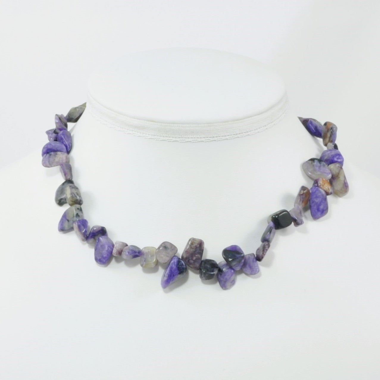 Necklace with purple and gray stones on a white background