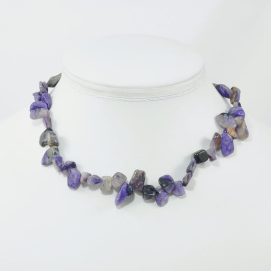 Necklace with purple and gray stones on a white background