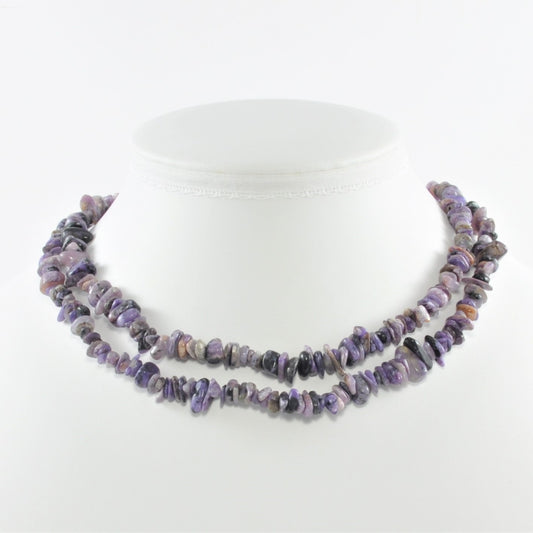 Purple beaded necklace on a white background