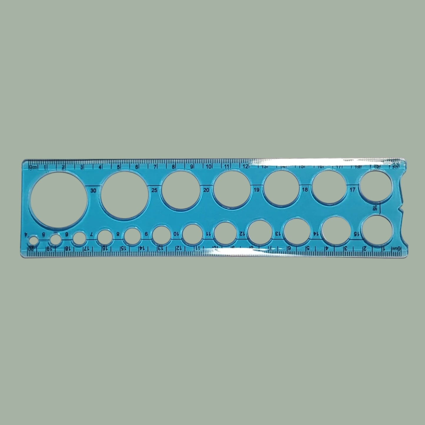 A blue plastic circular template ruler with multiple sizes of circular cutouts and printed measurement markings, shown on a plain light background.