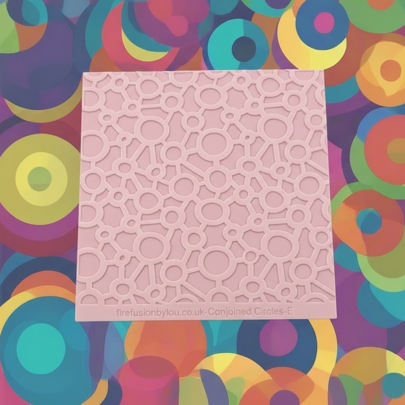 Conjoined circles. A continuous pattern embossed texture mat in pink material, size 100mm x 100mm. 
