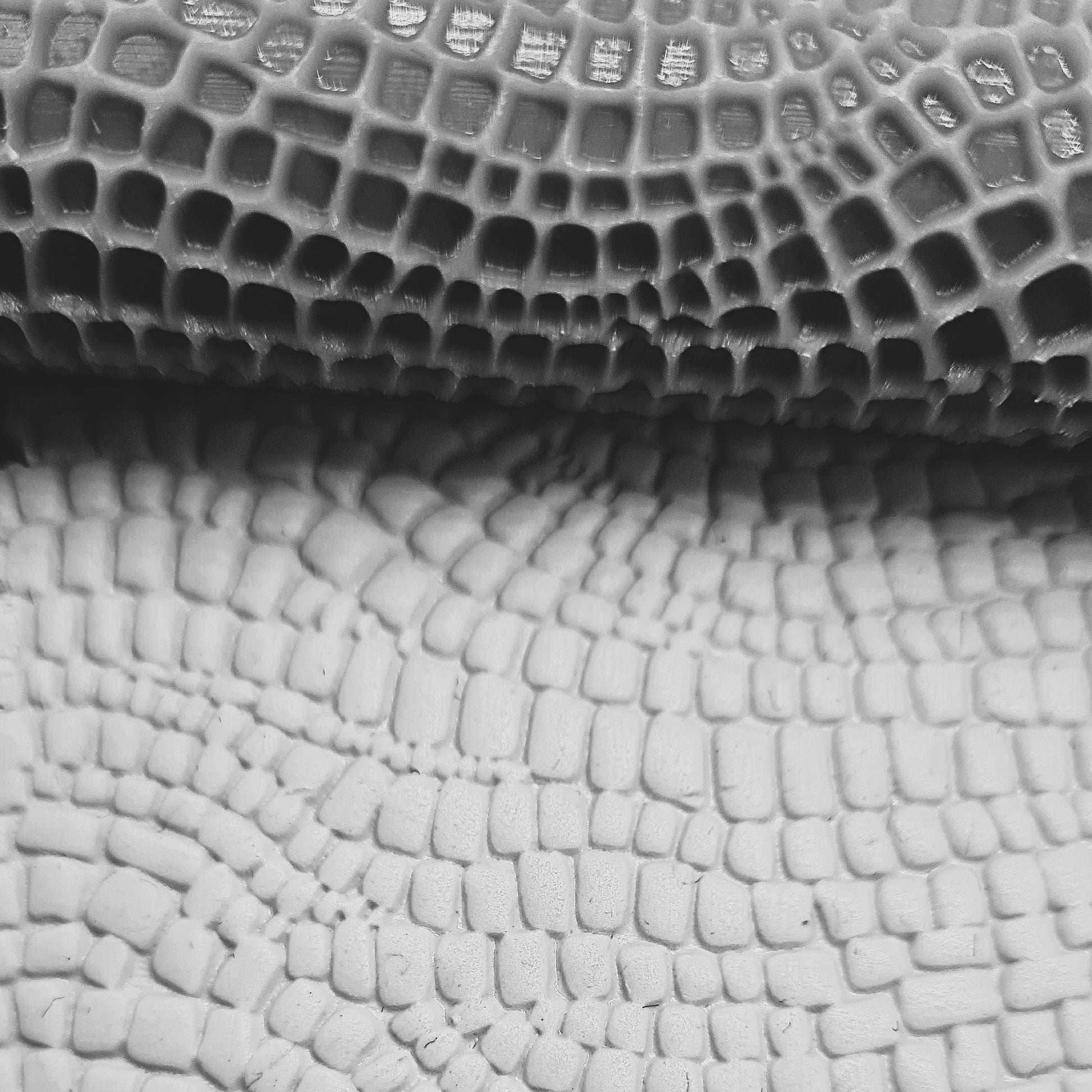 Close-up of textured crocodile pattern In clay