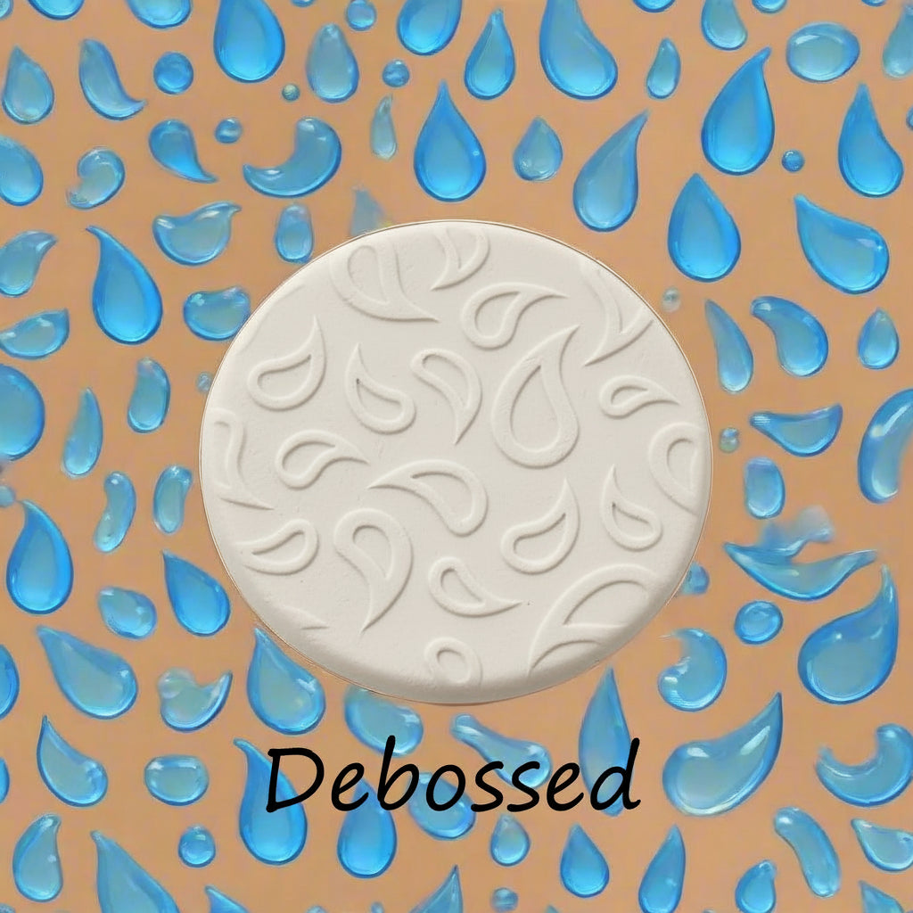 A raindrop pattern embossed in clay using a patterned debossed texture mat.