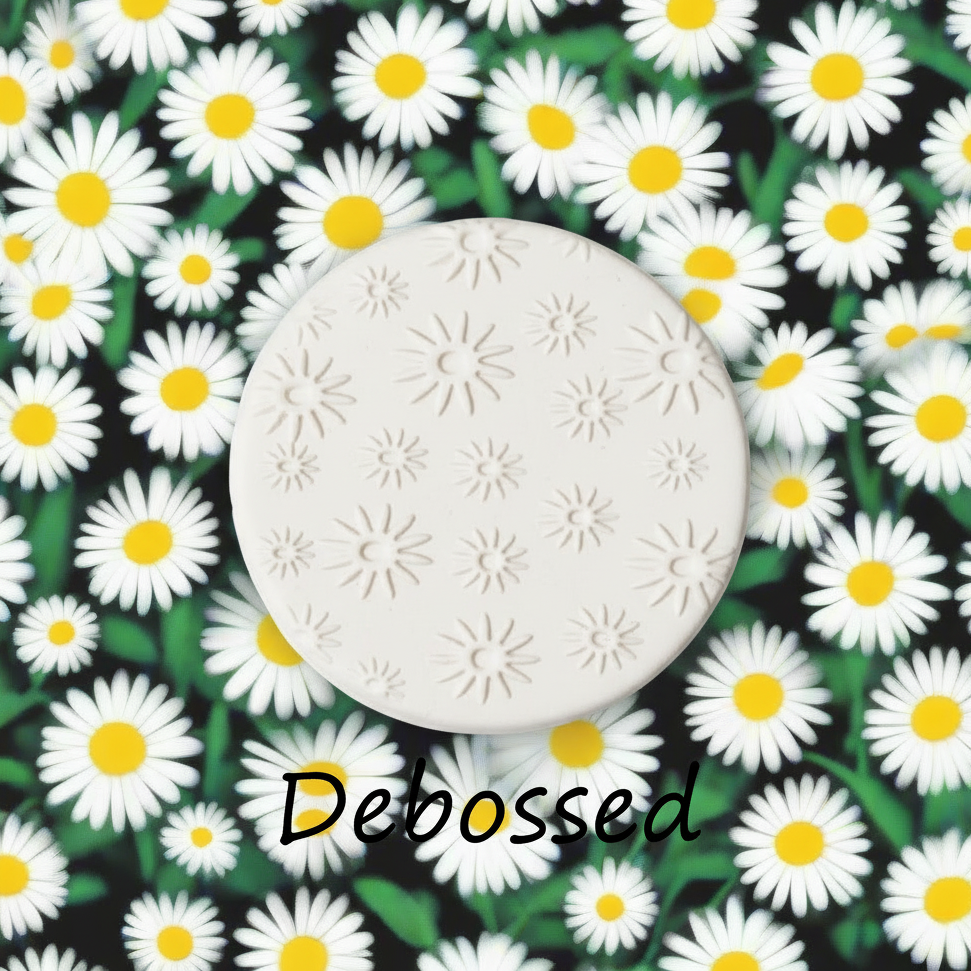 Daisy pattern embossed in clay using a  debossed texture.