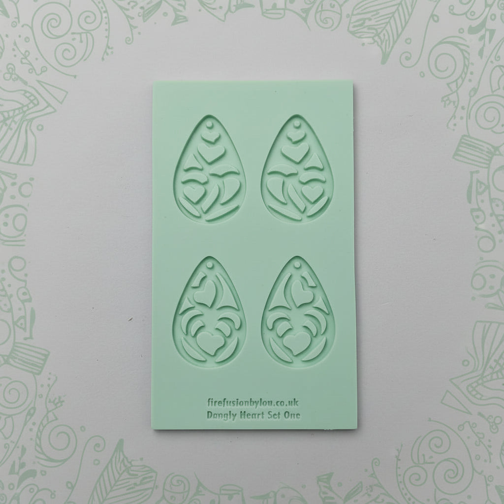 Set of earrings textures on a green rubber compound.