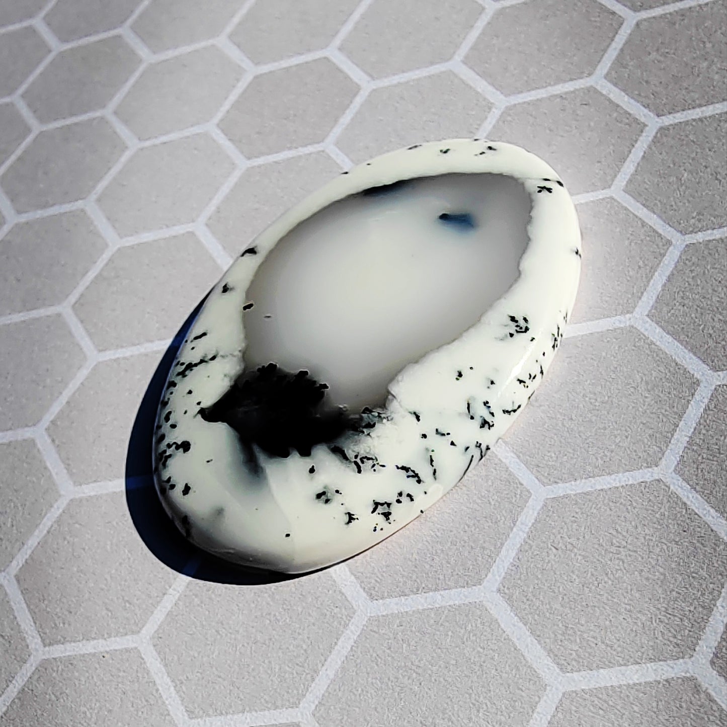Dendrite agate on a hexagonal background.
