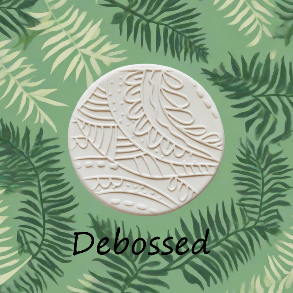A round, off-white ceramic tile with embossed leaf patterns, centered on a green background patterned with palm leaves. The word 'Debossed' is written in black script below the tile.