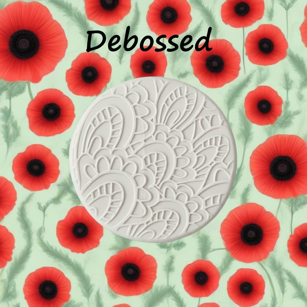 A pattern embossed in clay using a patterned debossed texture mat in grey. 