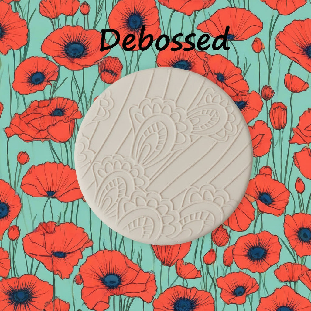 A pattern embossed in clay using a patterned debossed texture mat.