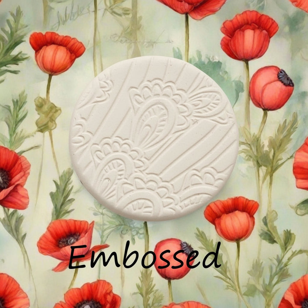 A pattern debossed in  clay using a patterned embossed texture mat.