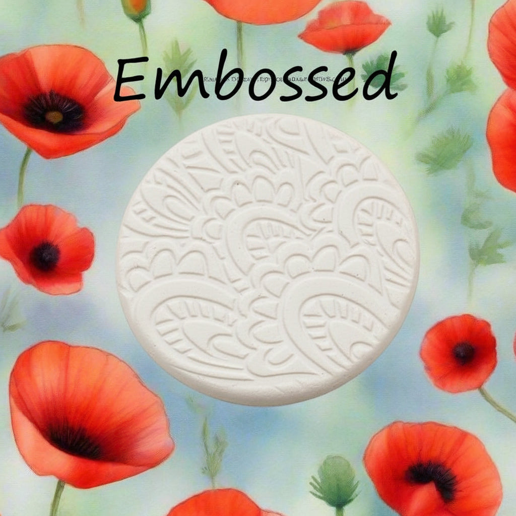 A pattern debossed in clay using a patterned embossed texture mat.