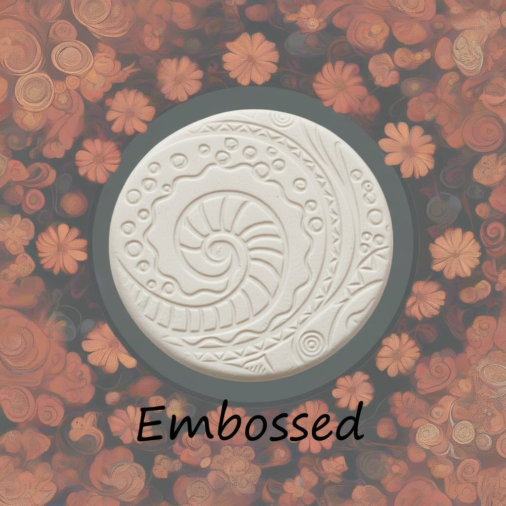 A pattern debossed in clay using a patterned embossed texture mat.