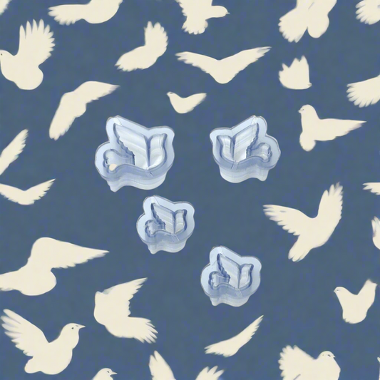 A set of four dove-shaped resin cutters of varying sizes, arranged on a blue background with flying birds.