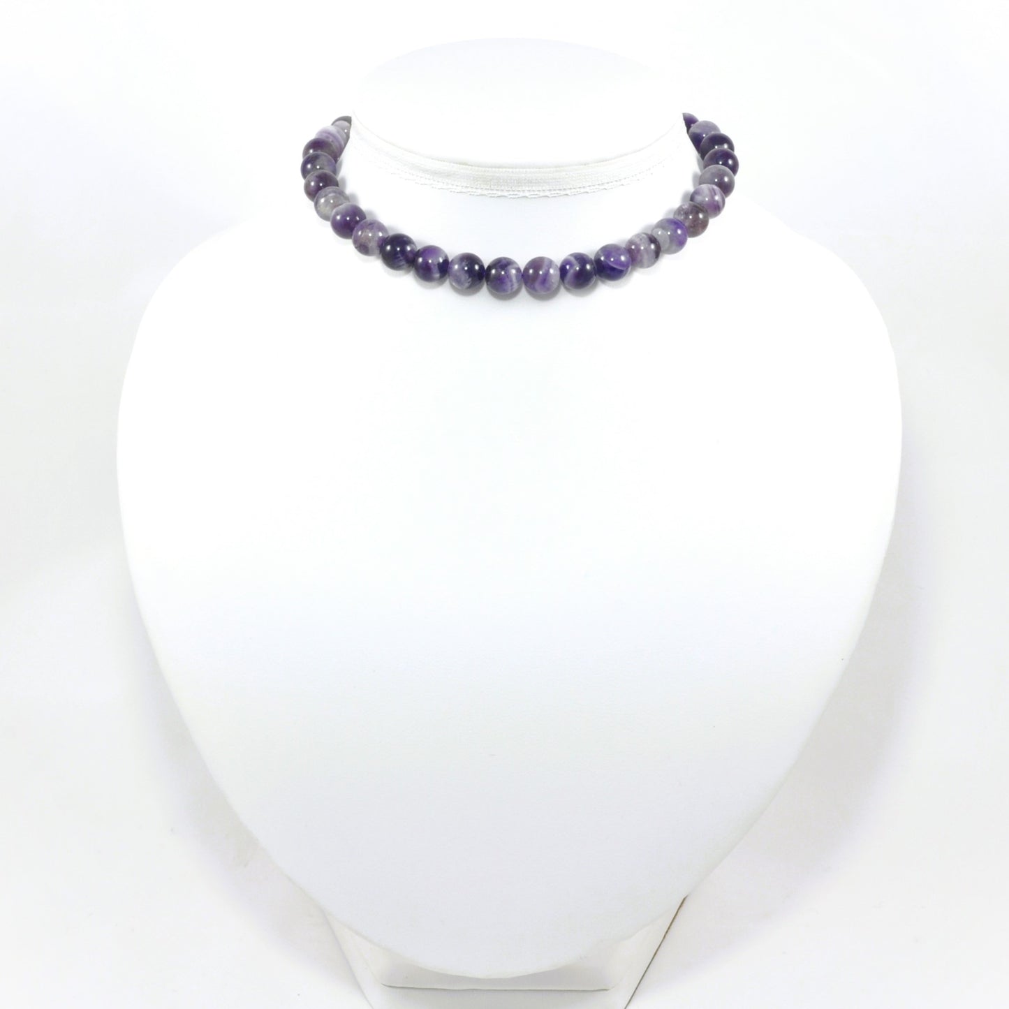 Necklace with purple beads on a white mannequin