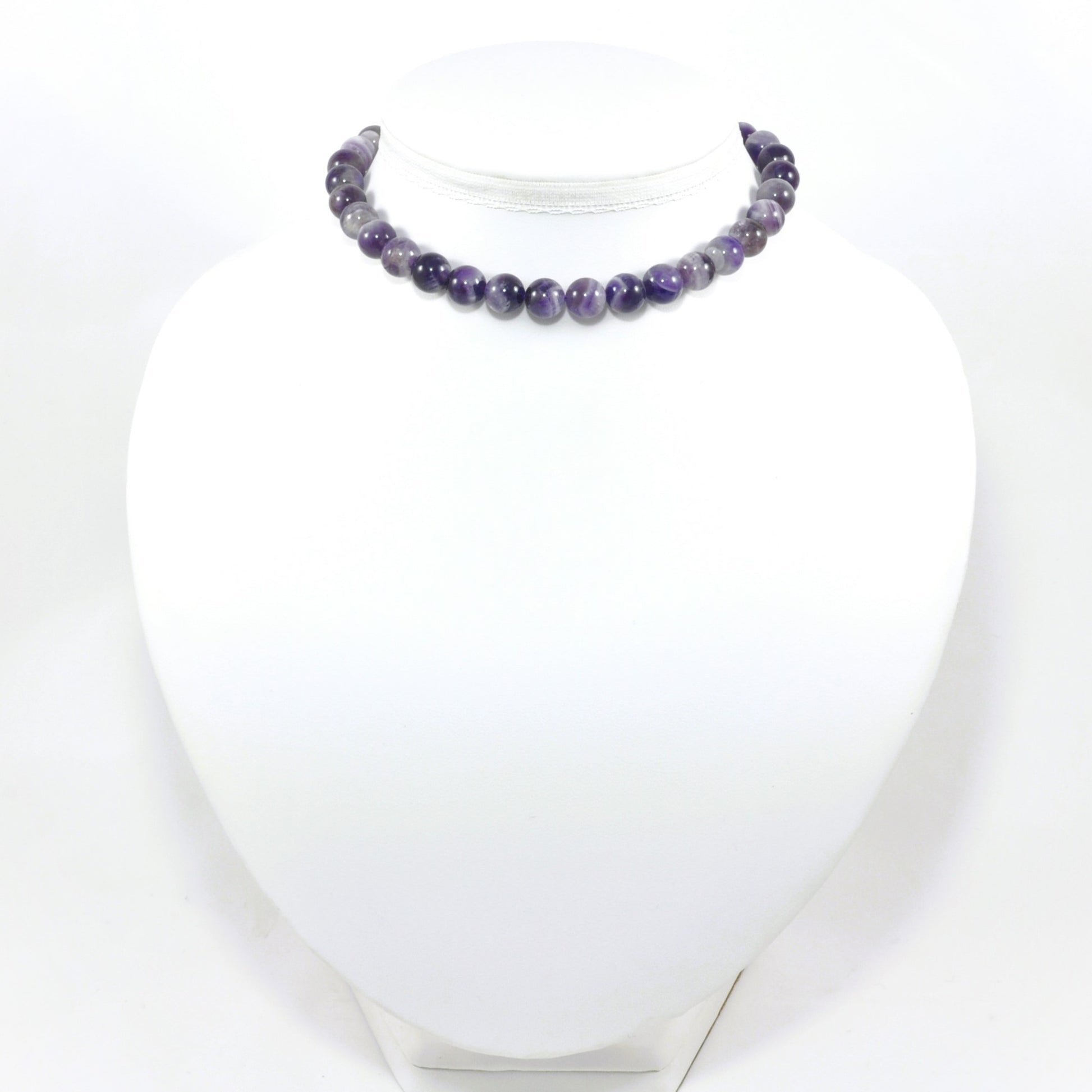 Necklace with purple beads on a white mannequin