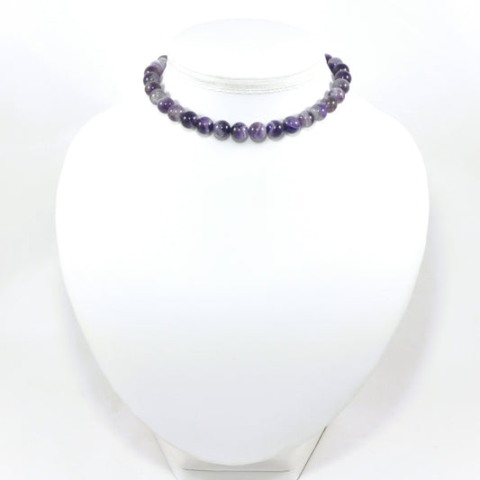 Necklace with purple beads on a white mannequin