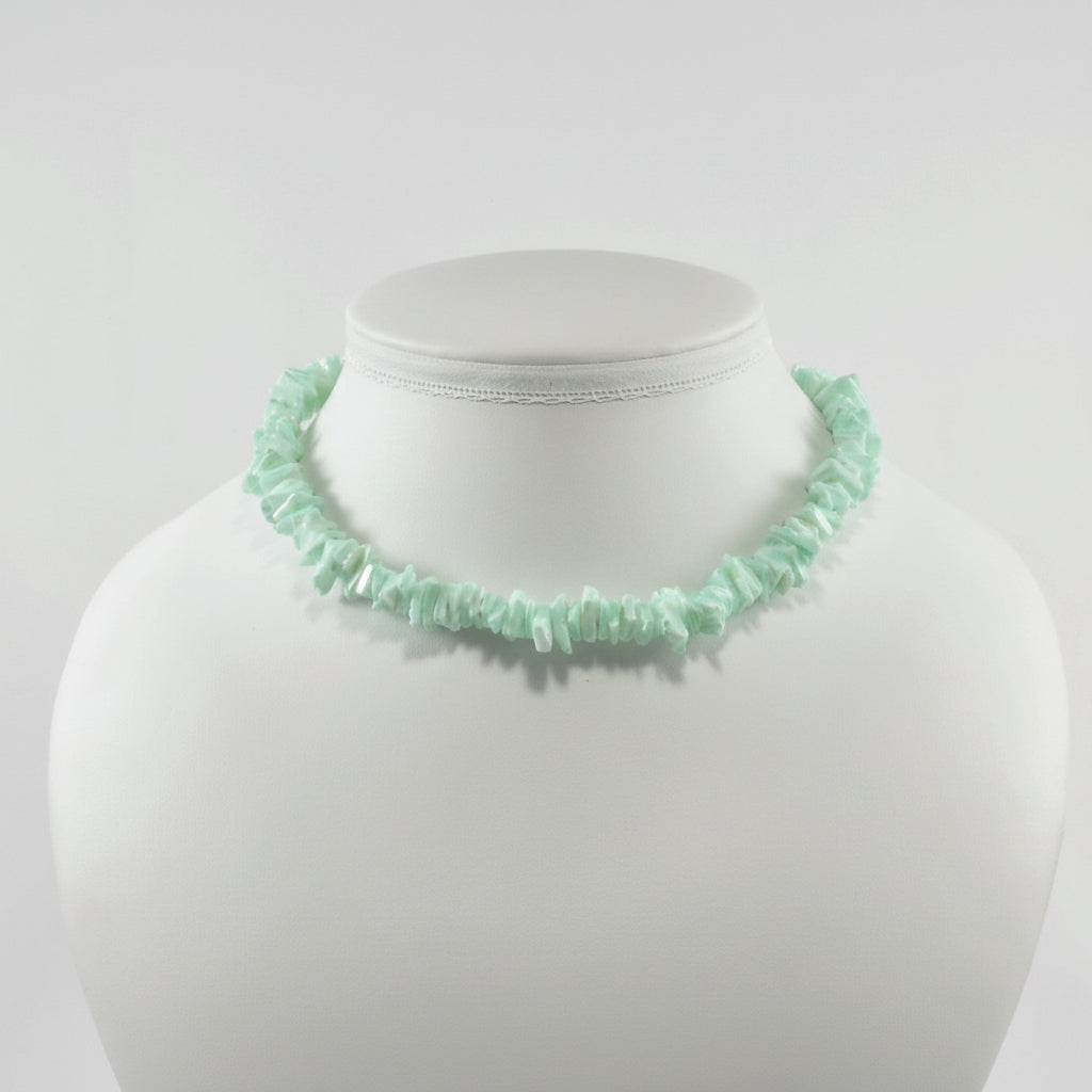 Mint green beaded necklace on a mannequin bust against a white background