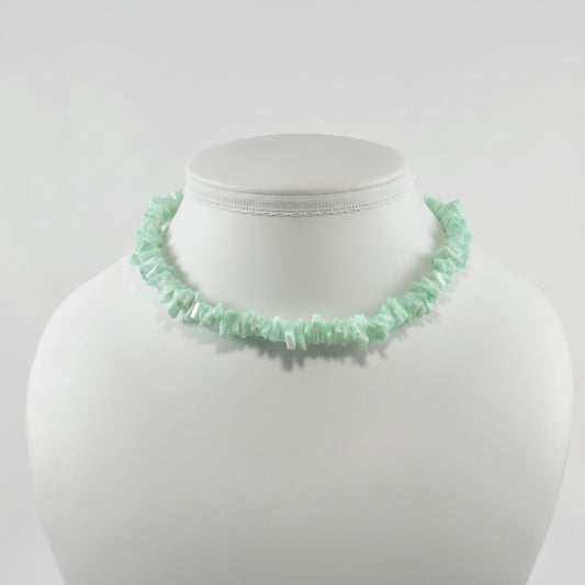 Mint green beaded necklace on a mannequin bust against a white background