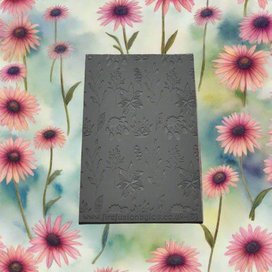 A 95 x 55 mm debossed texture mat with a flower design. Use to make a embossed impression on metal clay and polymer clay.