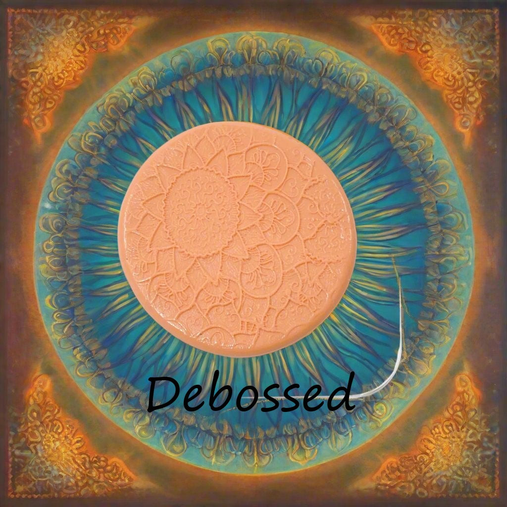 A flowery mandala pattern embossed in silly putty Using a debossed texture mat in grey material. This will give you an idea of what it will look like on metal clay or polymer clay.