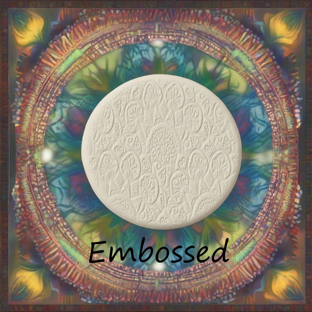 A flowery mandala pattern debossed in clay using an embossed texture mat of what it will look like on metal clay or polymer clay.