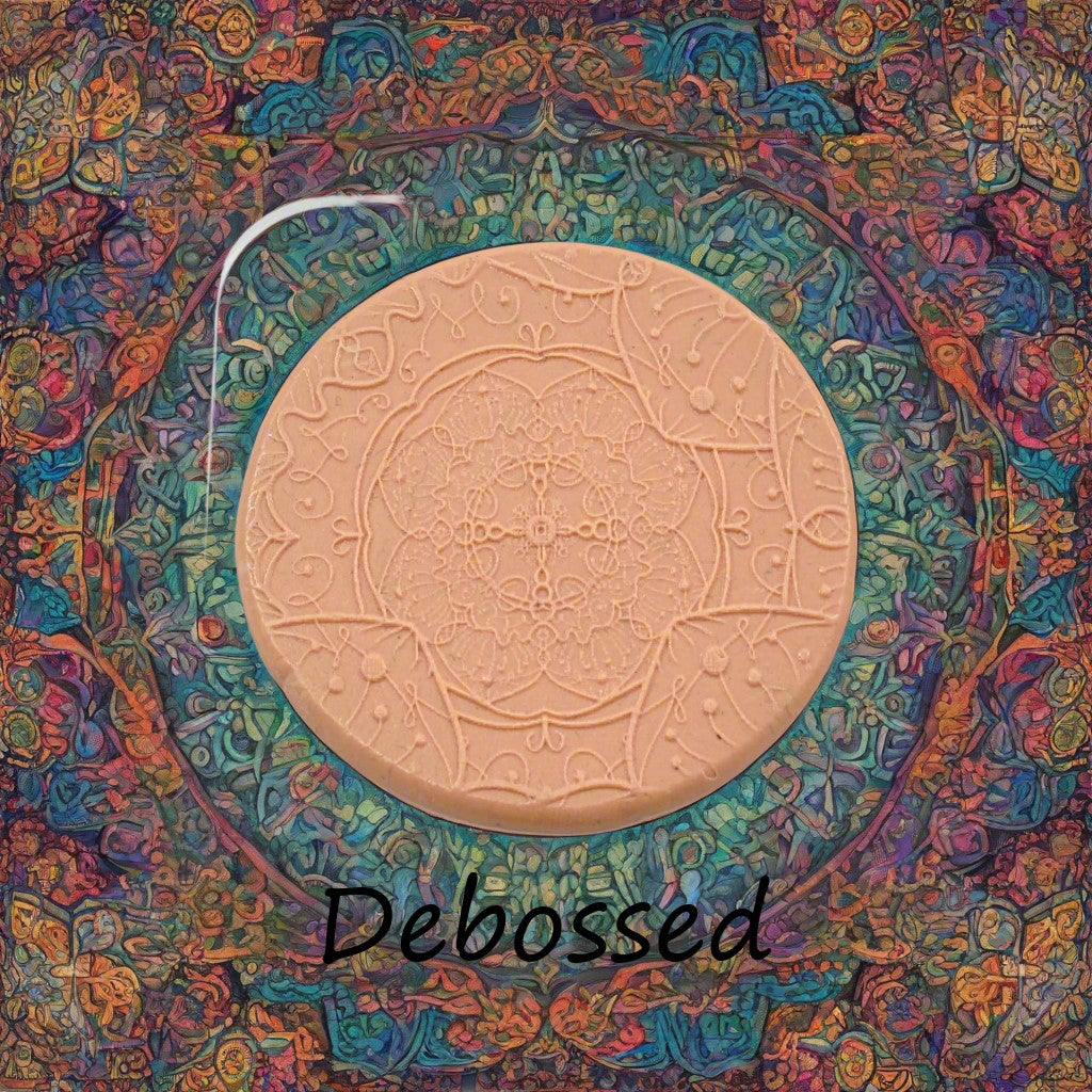 A flowery mandala pattern embossed in silly putty Using a debossed texture mat in grey material. This will give you an idea of what it will look like on metal clay or polymer clay.