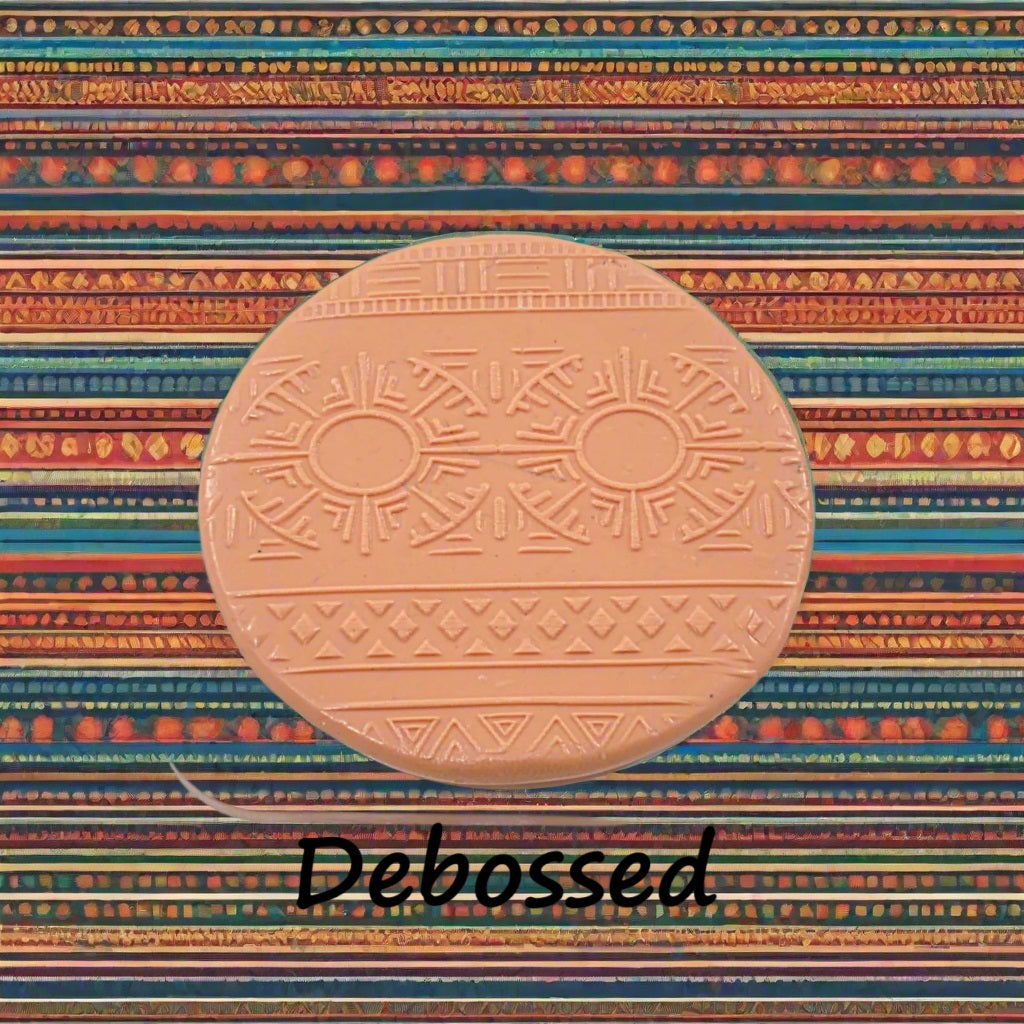 A pattern embossed in silly putty Using an ethnic design debossed texture mat in grey material. This will give you an idea of what it will look like on metal clay or polymer clay.